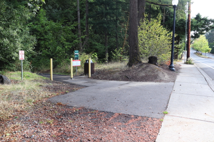 Connector trail from street — natural surface trail to main trail — signage and garbage can